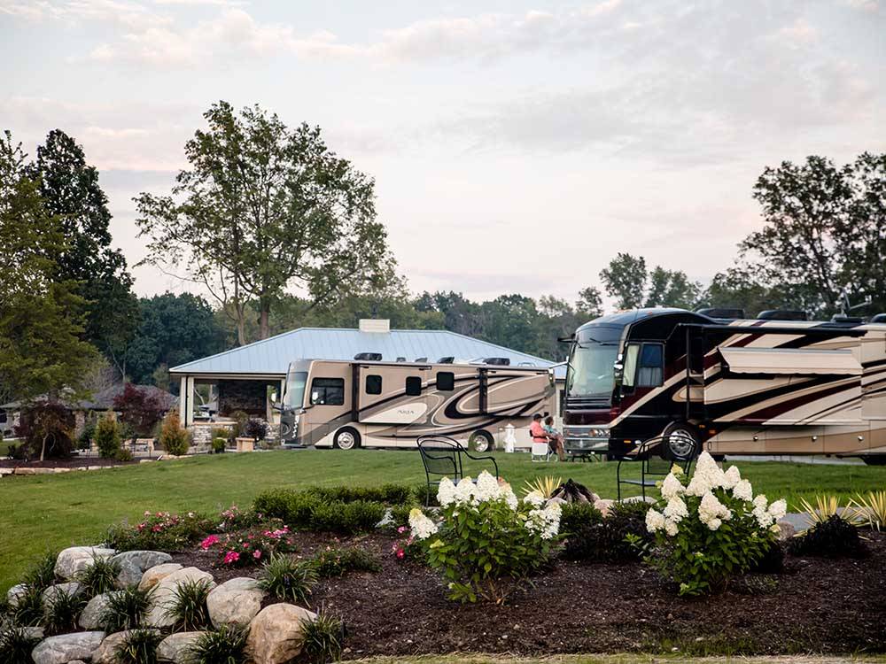Two motorhomes parked next to a pavilion at MOTORCOACH RESORT LAKE ERIE SHORES