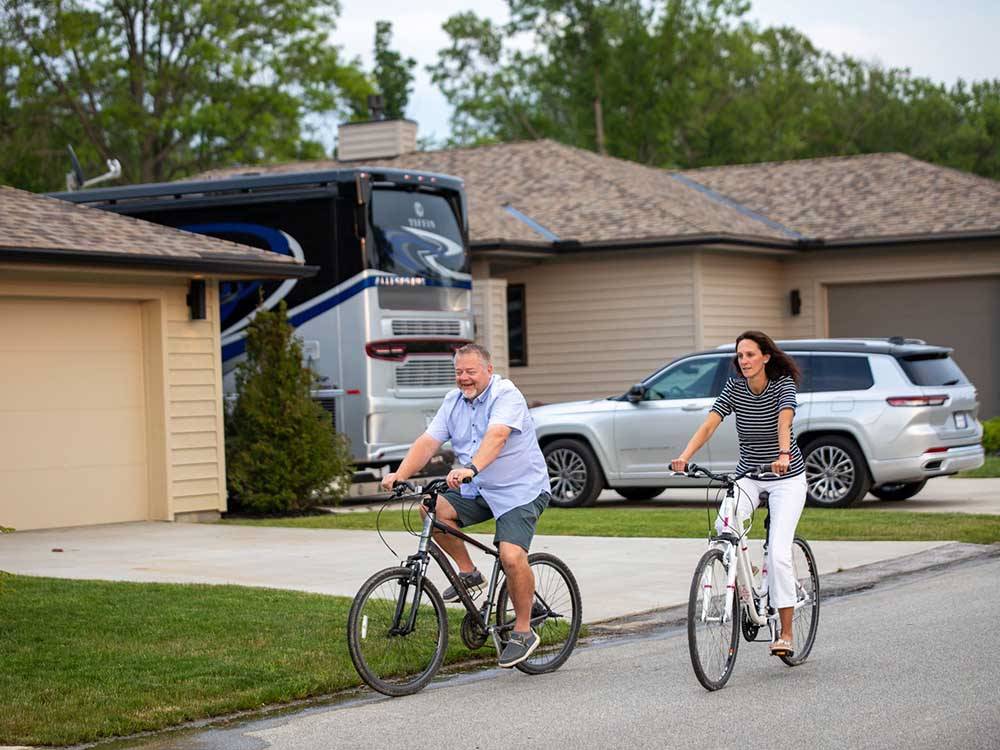 A couple riding bicycles at MOTORCOACH RESORT LAKE ERIE SHORES