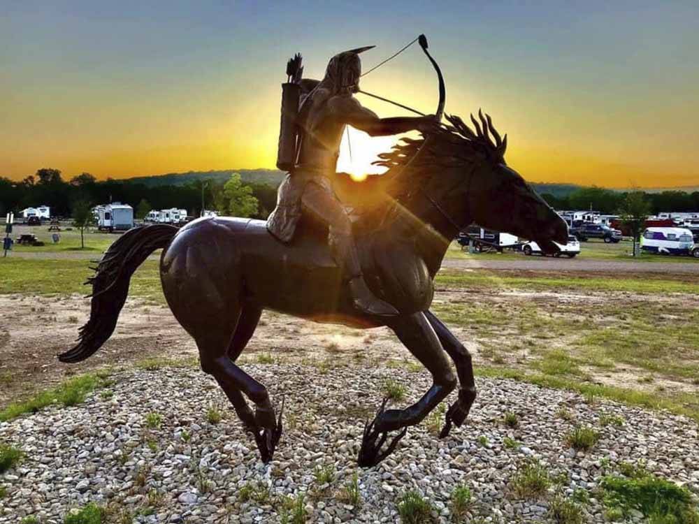 A statue of an Indian shooting an arrow from horseback at DINOSAUR VALLEY RV PARK