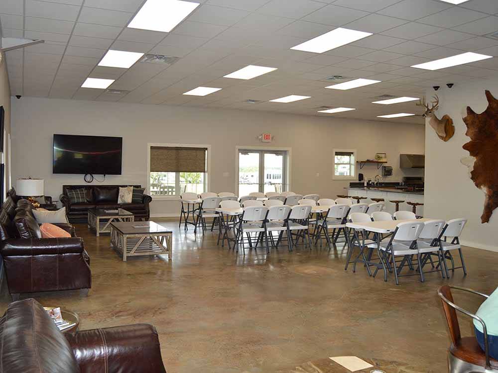 Inside sitting area with folding tables and chairs at BRAZOS TRAIL RV PARK