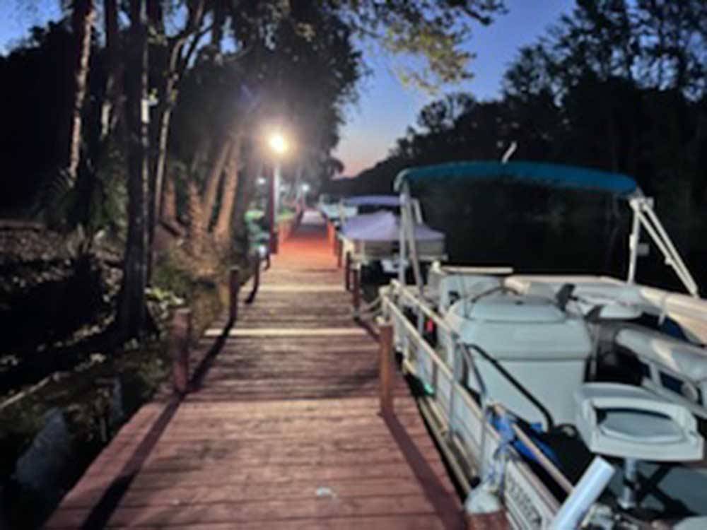 Tree lined boat dock at sunset at HAINES CREEK RV PARK
