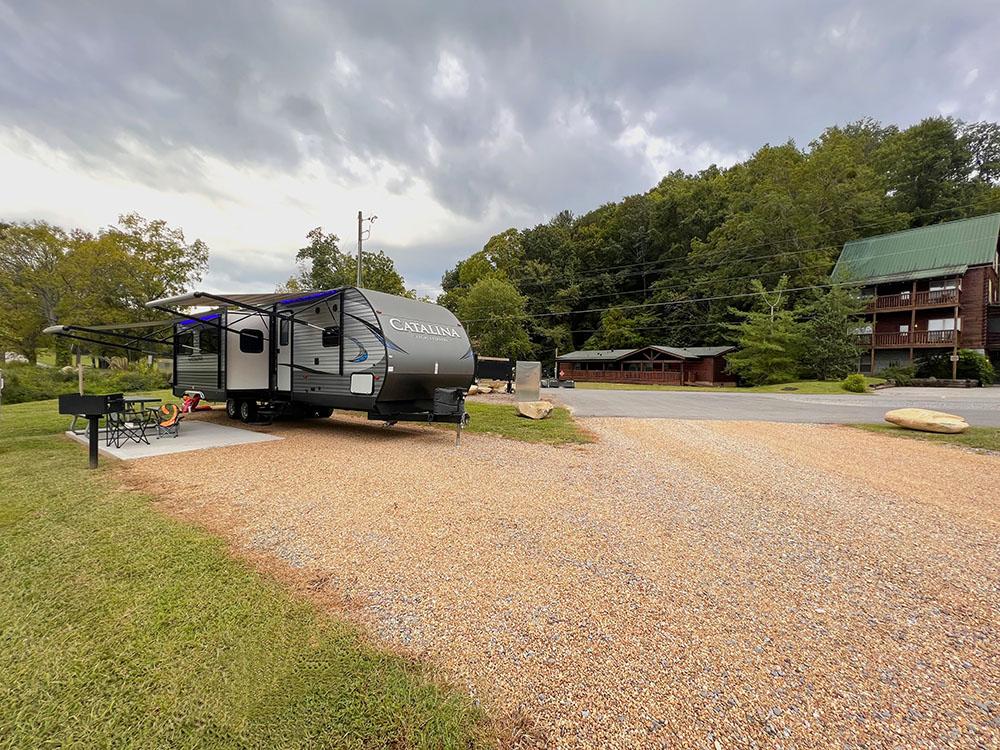 RV space with grill, fire pit, and table at APPALACHIAN SPRINGS OUTDOOR RESORT