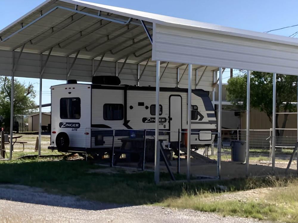 Covered parked trailer at site American Campground