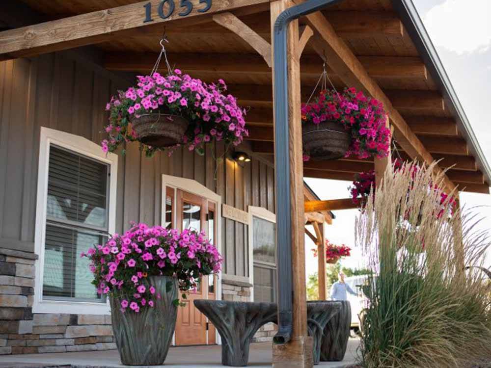 The front covered porch with flowers at COOL SUNSHINE RV PARK