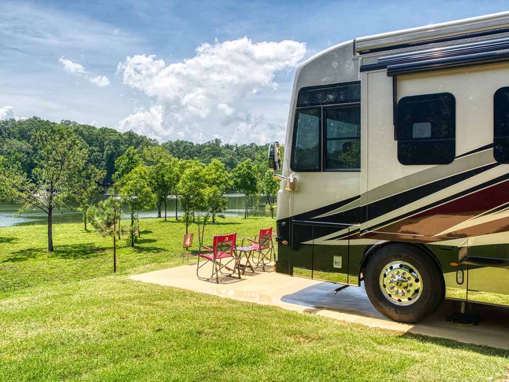 A motorhome in an RV site overlooking the water at TWIN CREEKS RV RESORT