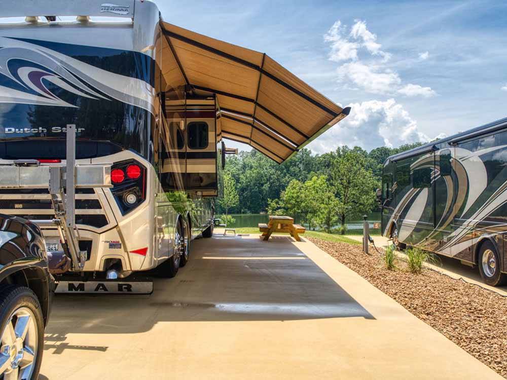 A motorhome in an paved RV site at TWIN CREEKS RV RESORT