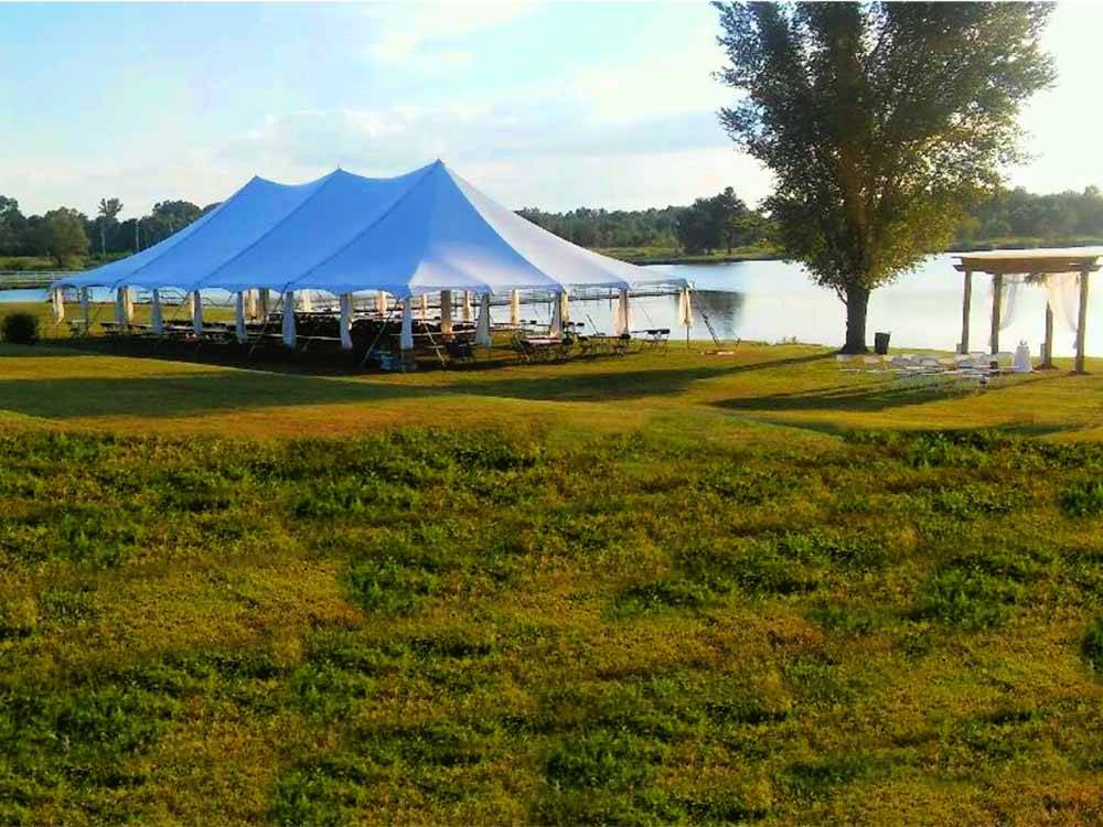 A large event tent by the water at COOK'S LAKE RV RESORT & CAMPGROUND