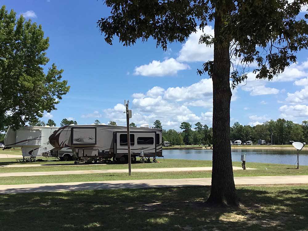 Motorhome in campsite overlooking the water at THOMPSON LAKE RV RESORT