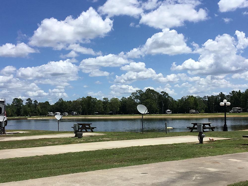 Paved sites with picnic tables by the lake at THOMPSON LAKE RV RESORT