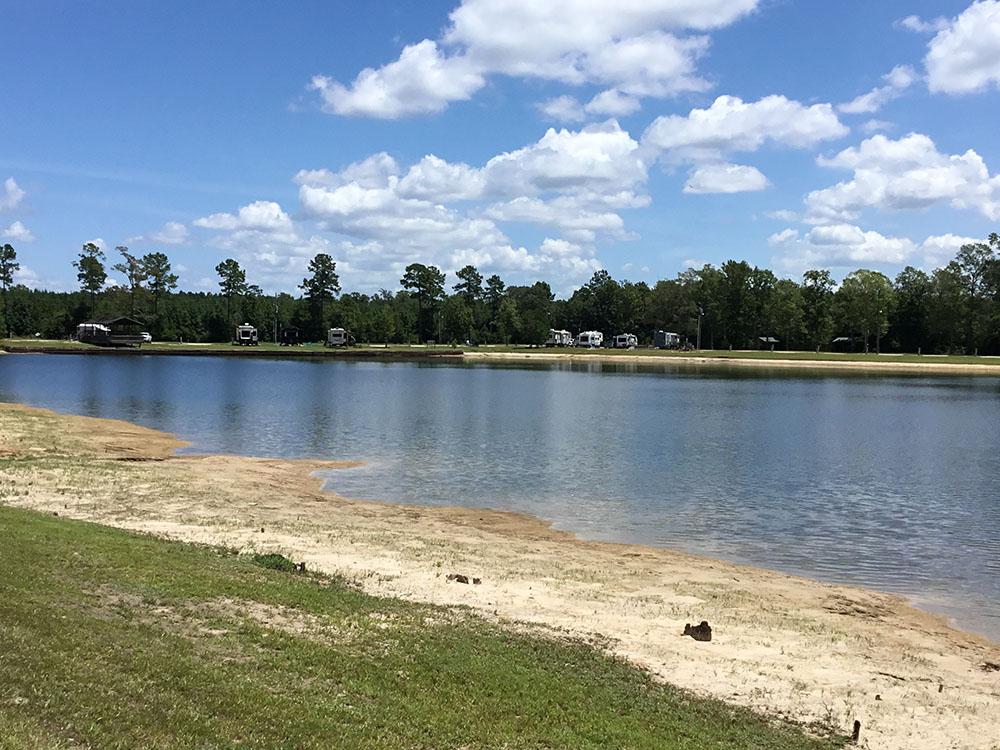 A view of the lake from the sandy shore at THOMPSON LAKE RV RESORT