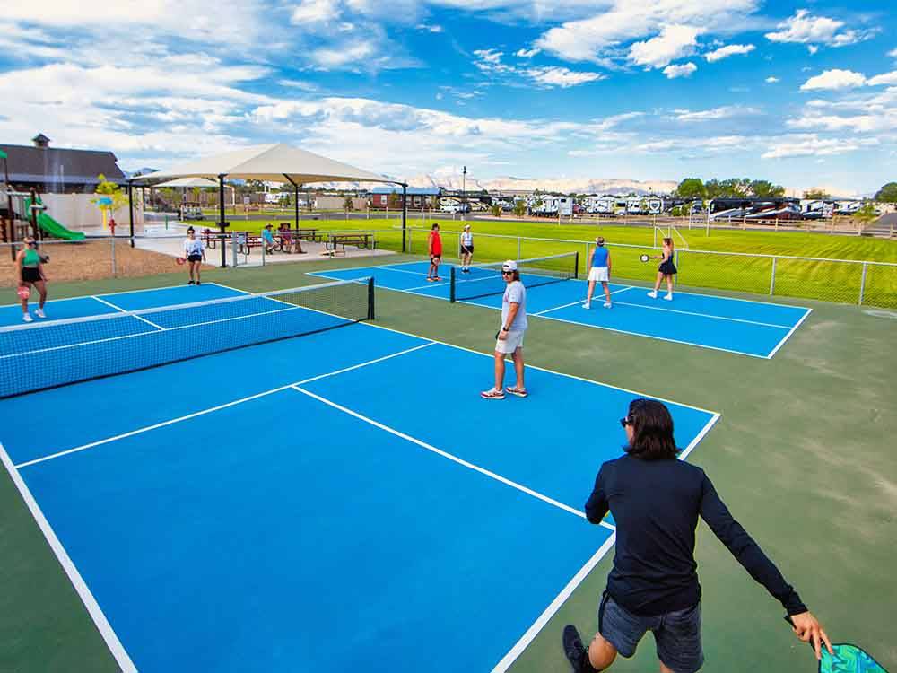 Playing pickleball on blue courts at CANYON VIEW RV RESORT