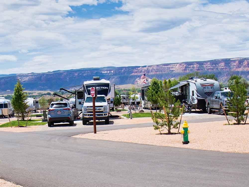 Campsites with rock bluffs looming on the horizon at CANYON VIEW RV RESORT