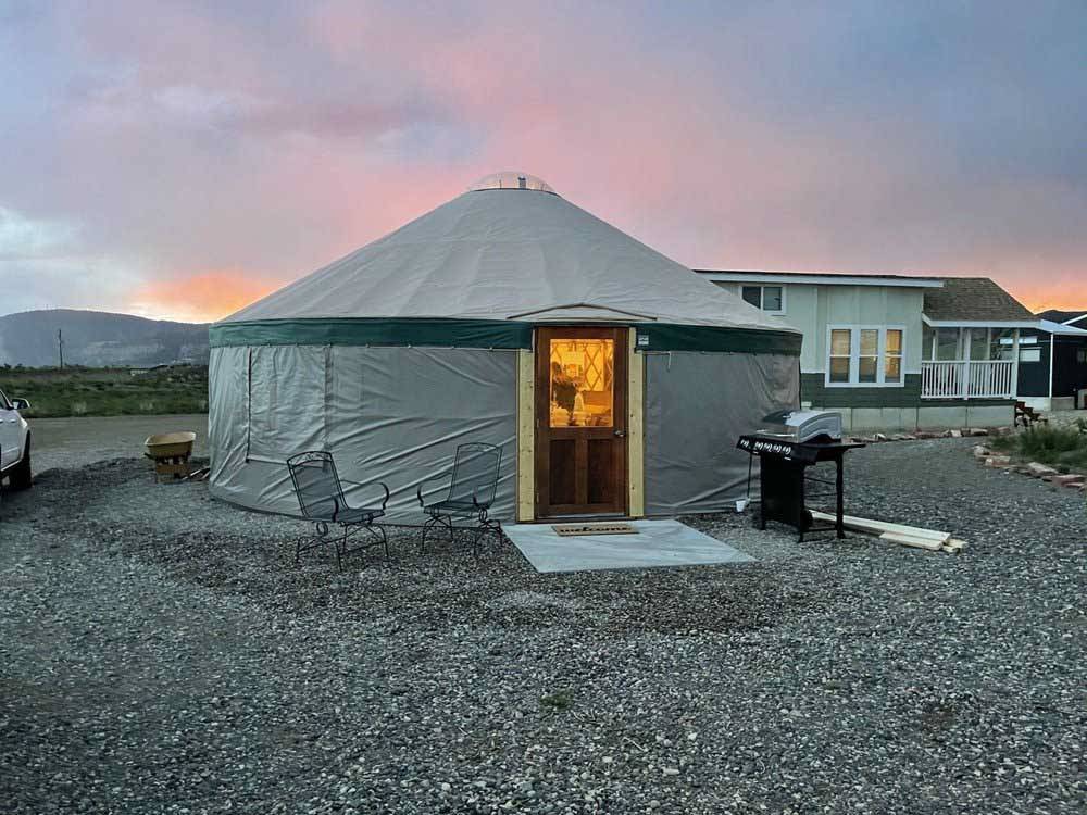 Exterior view of yurt available for rent at TRAIL & HITCH RV PARK AND TINY HOME HOTEL