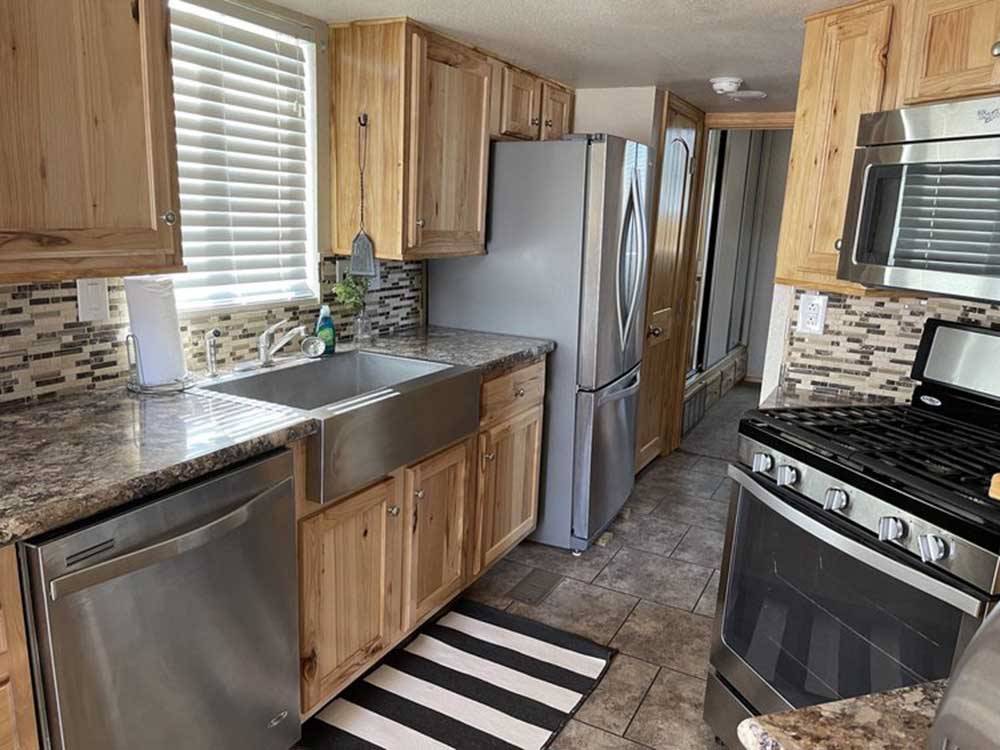 Kitchen area of White River Casita tiny home model at TRAIL & HITCH RV PARK AND TINY HOME HOTEL