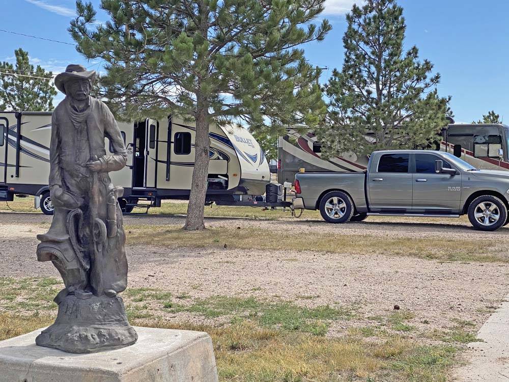 A statue next to a gravel RV site at PINE BLUFFS RV RESORT BY RJOURNEY