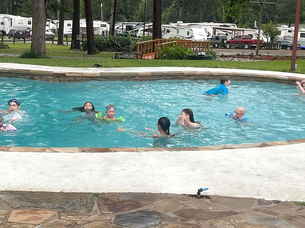 People playing in the pool at FOREST LAKE RV PARK & EVENTS