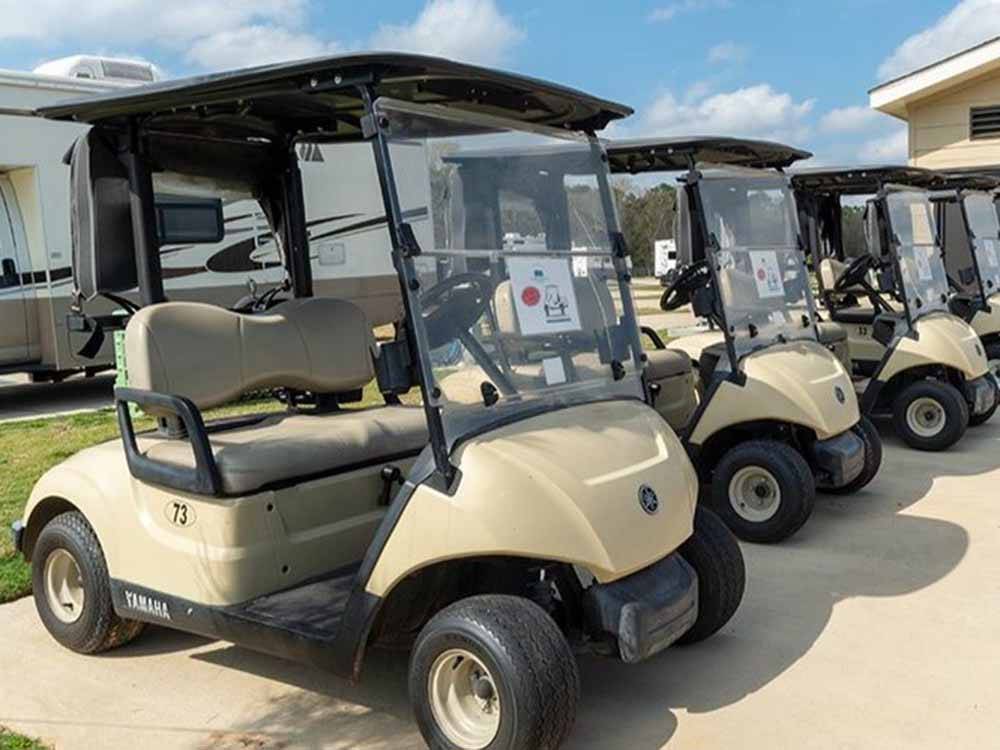 A row of golf carts parked at ERIC & JAY'S RV RESORT