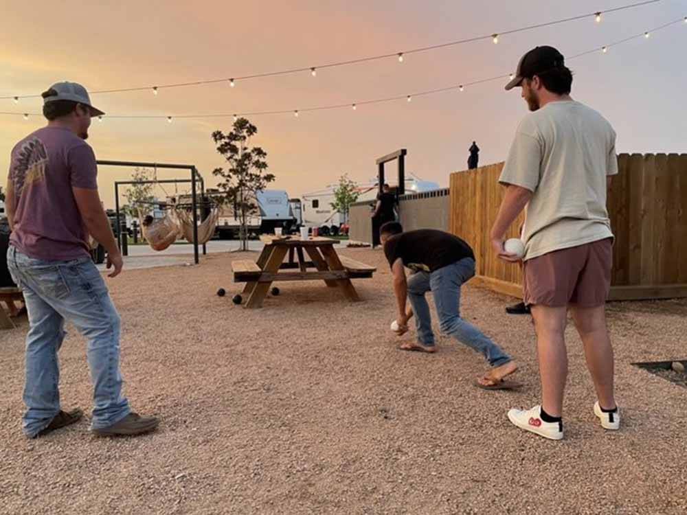 A couple of men playing bocce ball at ERIC & JAY'S RV RESORT