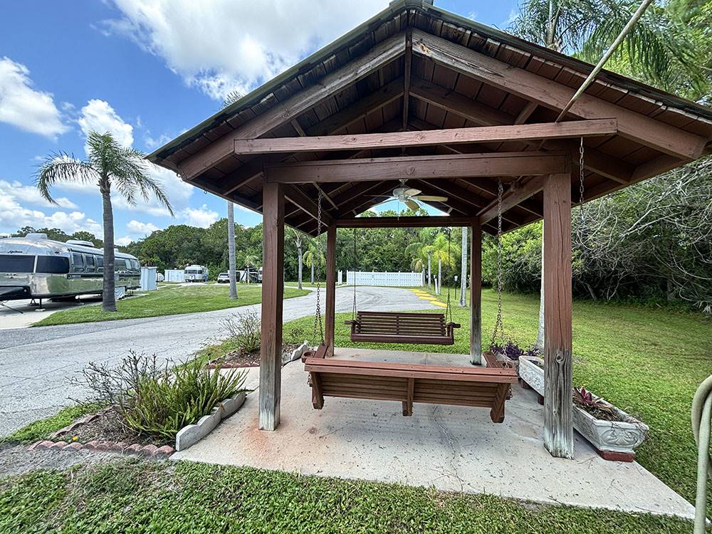 Covered bench swings