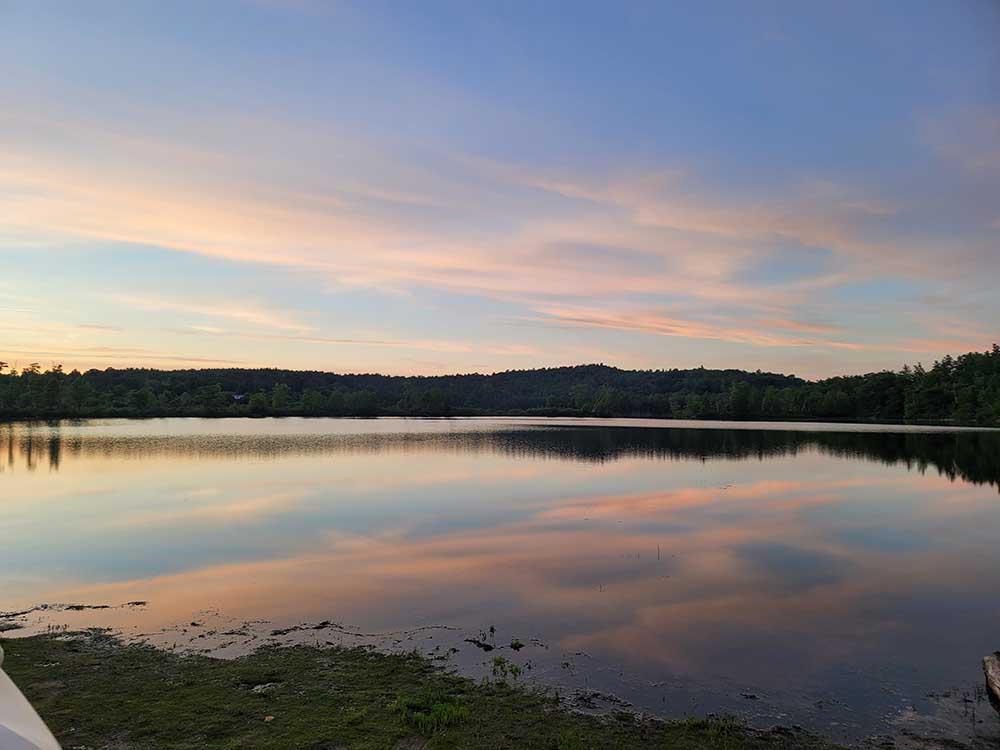 A view of the lake at sunset at QUINEBAUG COVE RESORT