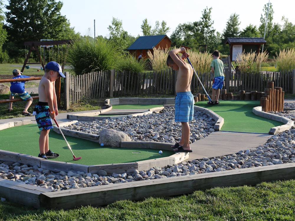 Kids playing miniature golf at Jetstream RV Resort at Stone Oak Ranch