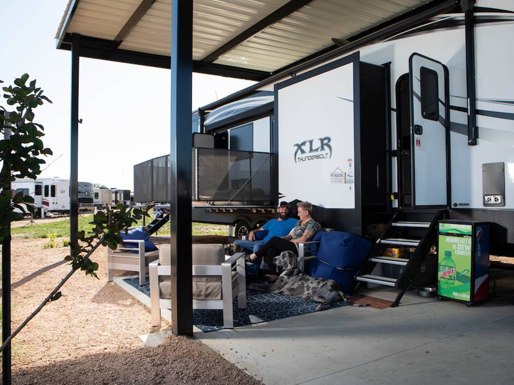 A couple sitting in front of their parked RV at Jetstream RV Resort at Stone Oak Ranch