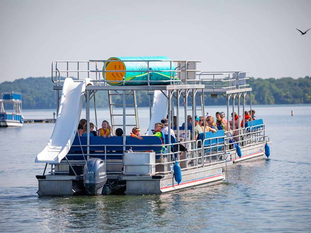 A group of people on a pontoon boat at FOUR CORNERS RV RESORT
