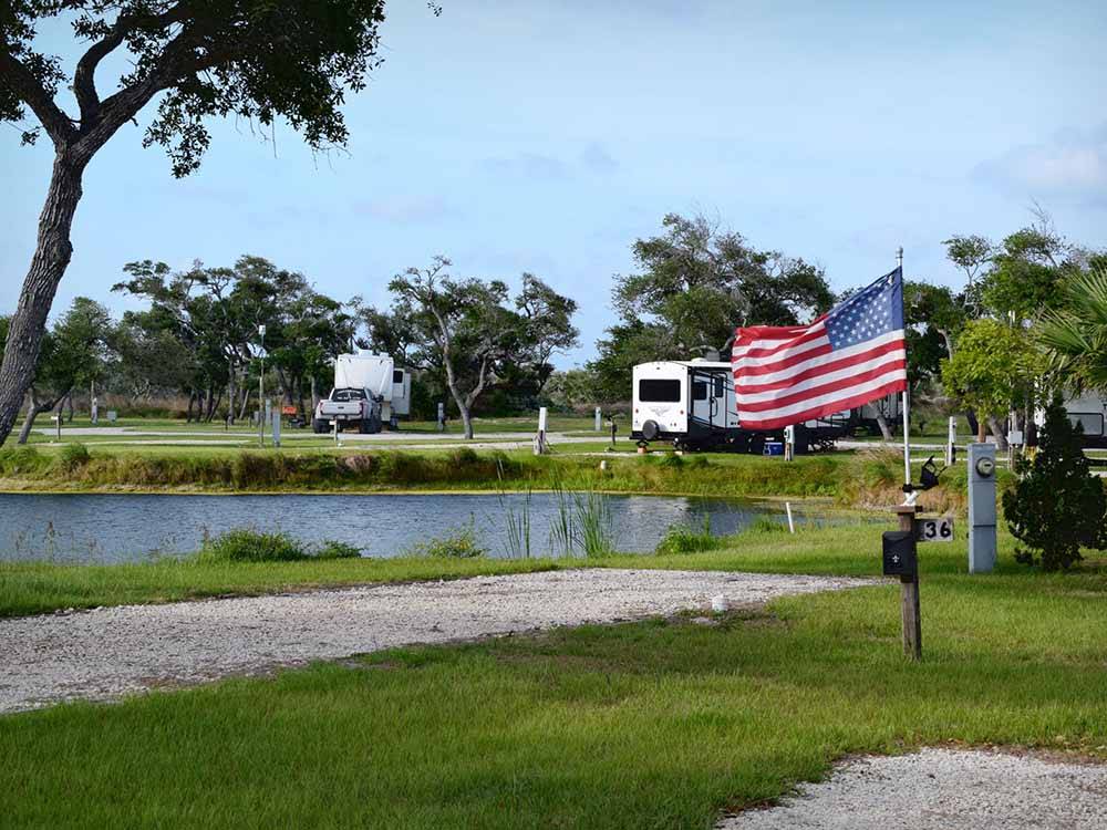 An American flag next to an RV site at QUILLY'S BIG FISH RV PARK