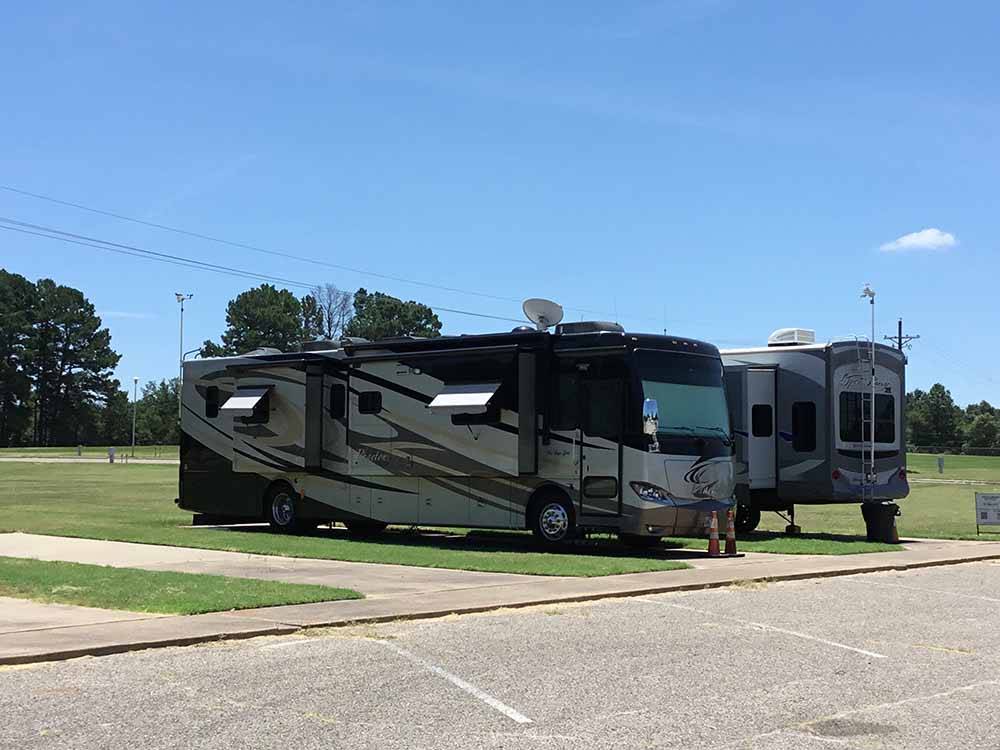 A couple of RVs in paved RV sites at MINEOLA CIVIC CENTER & RV PARK