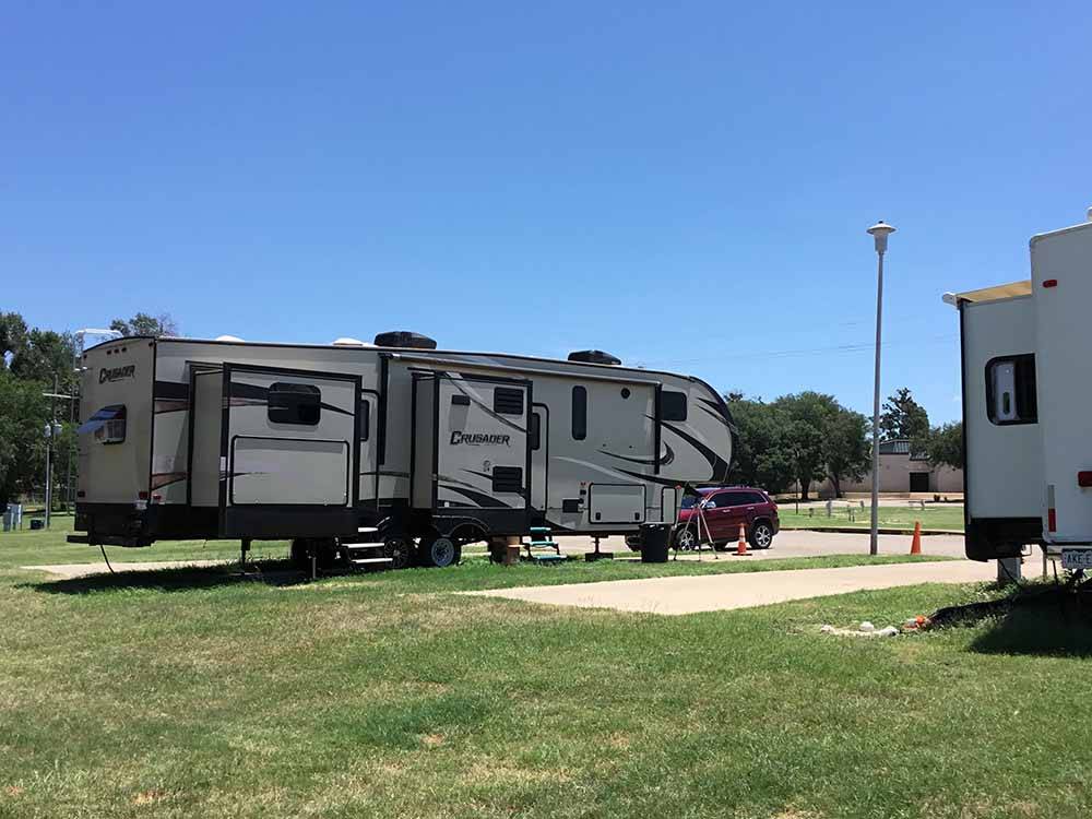 A row of paved back in RV sites at MINEOLA CIVIC CENTER & RV PARK