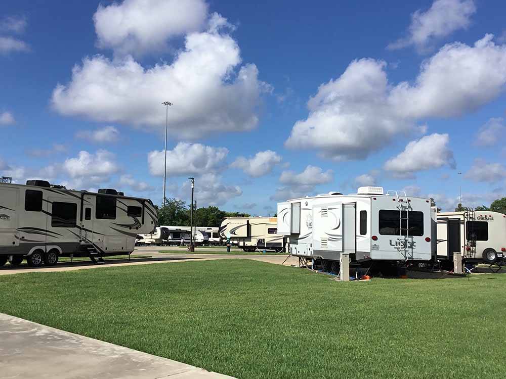 A grassy area next to a group of RV sites at BEAUMONT RV & MARINA