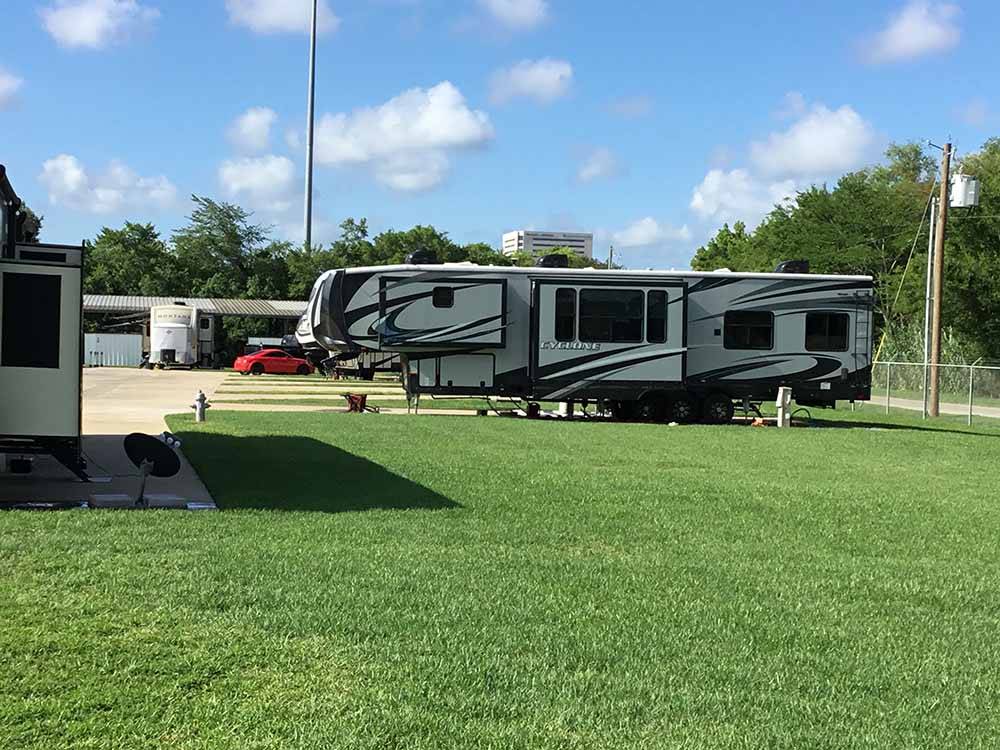 A fifth wheel trailer in a paved RV site at BEAUMONT RV & MARINA