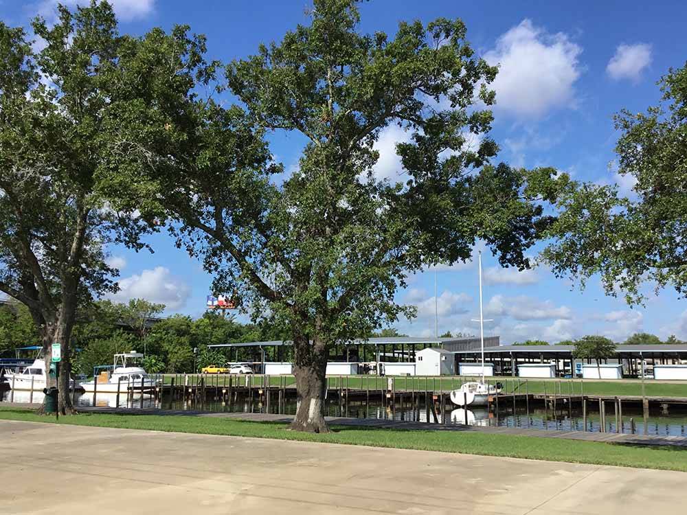 A row of boat docks with a tree at BEAUMONT RV & MARINA