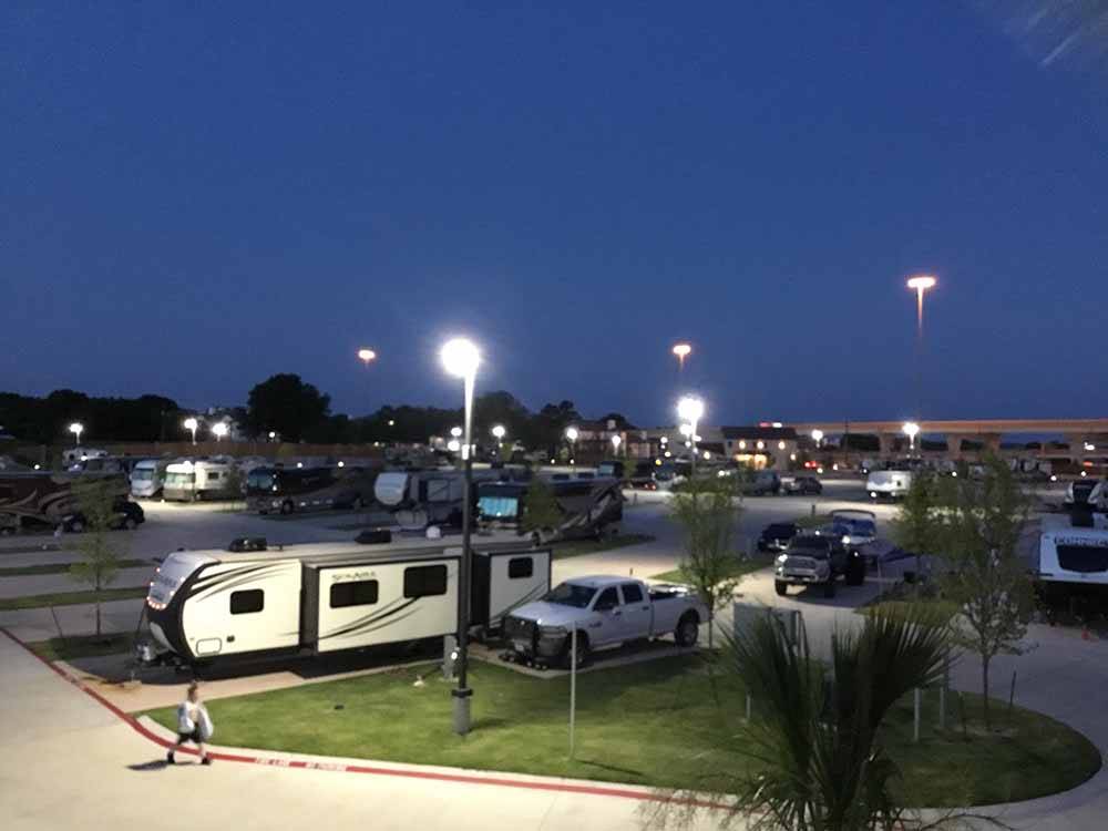 A truck and travel trailer parked in a site at night at LAKESHORE RV RESORT