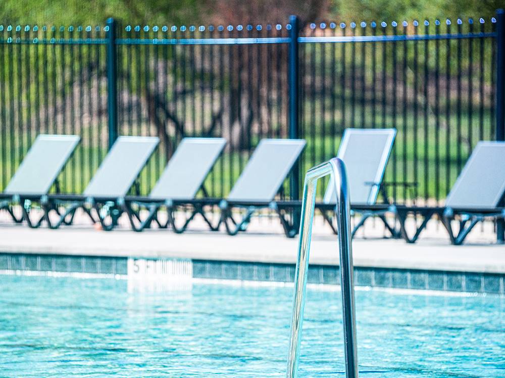 Lounge chairs surrounding the pool at Riverwalk RV Resort