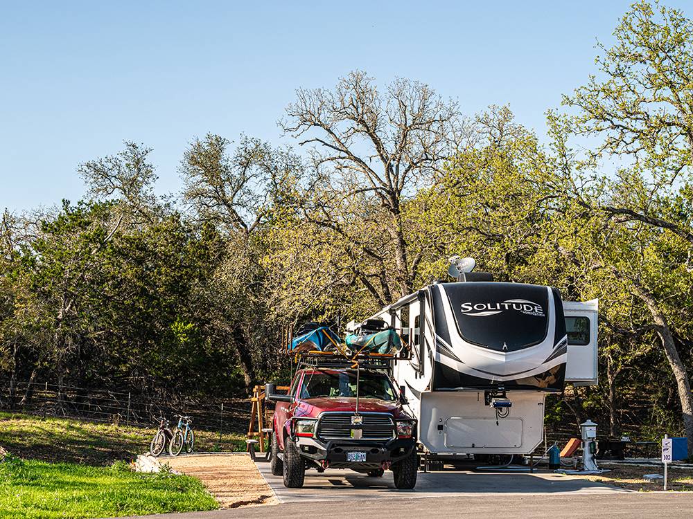 A fifth wheel and truck parked at a site at Riverwalk RV Resort