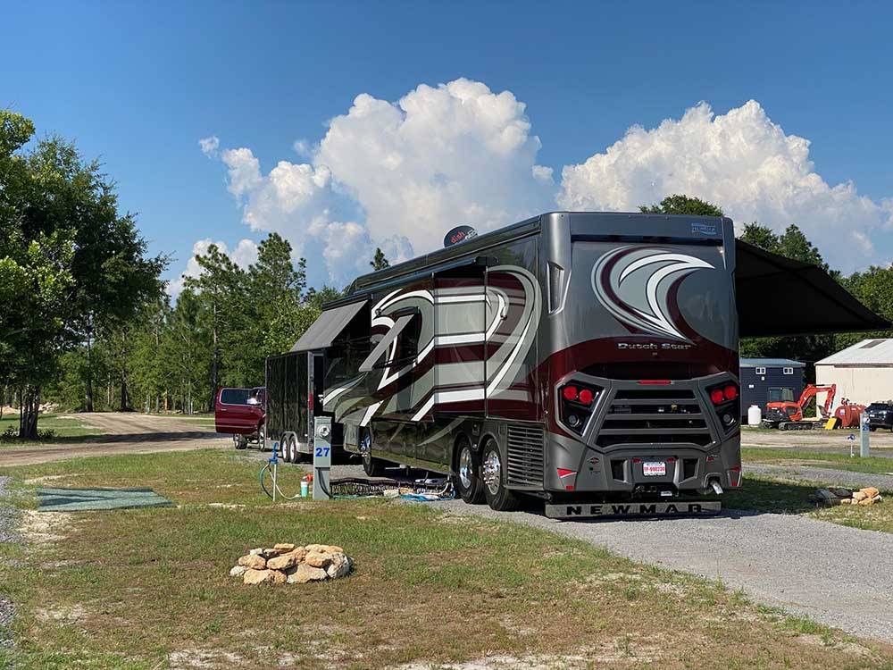 A motorhome in a paved RV site at BIG RIG FRIENDLY RV RESORT