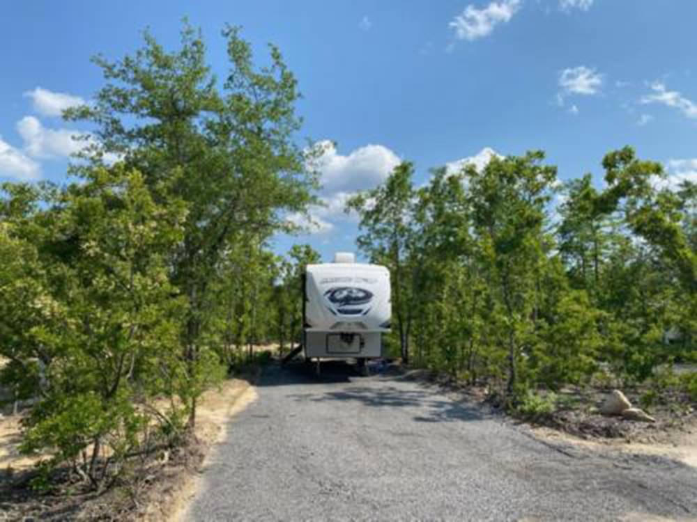 Fifth wheel trailer backed in at a gravel site at BIG RIG FRIENDLY RV RESORT