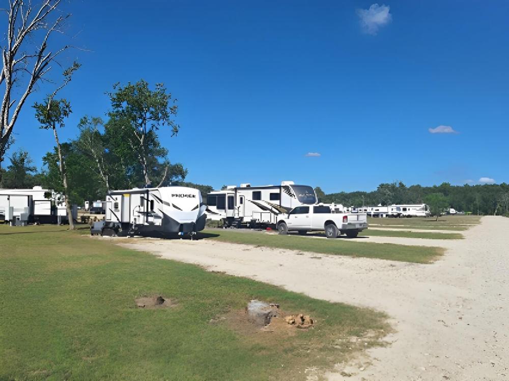 Open RV space near parked trailer at St. Ives RV Resort