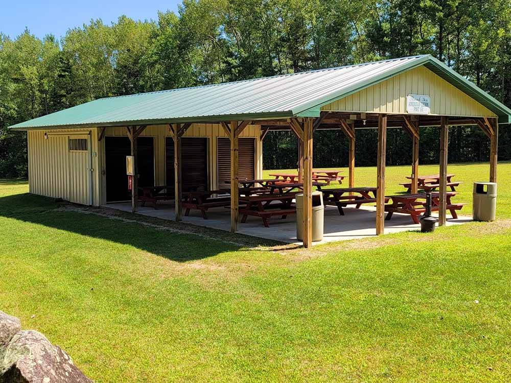 A pavilion with picnic tables at EVERGREEN PARK & CAMPGROUND