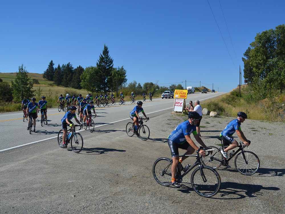 Several bicyclists in blue shirts and black shorts at SUMMIT RV RESORT