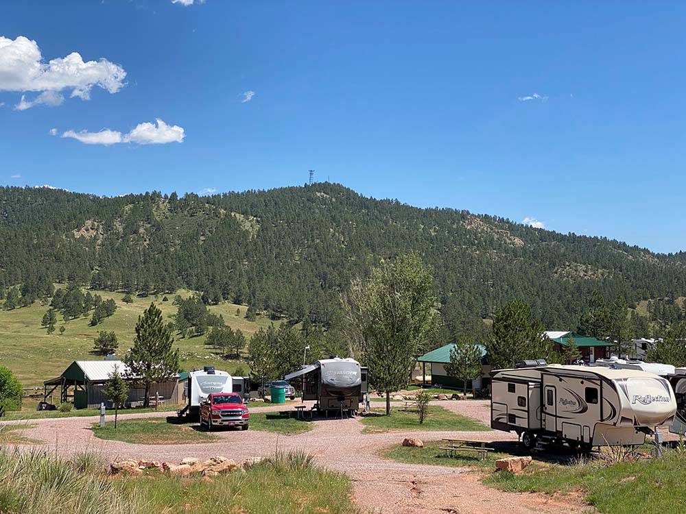 View of three fifth wheels in RV sites at SUNRISE RIDGE CAMPGROUND