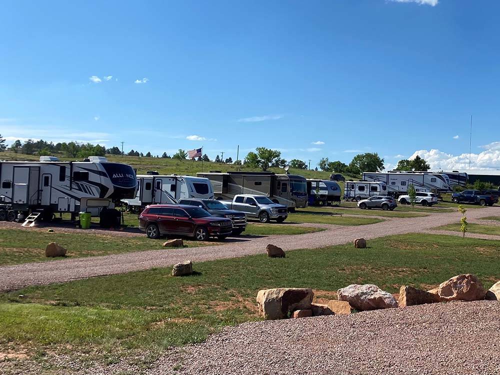 A row of RVs and cars parked in sites at SUNRISE RIDGE CAMPGROUND