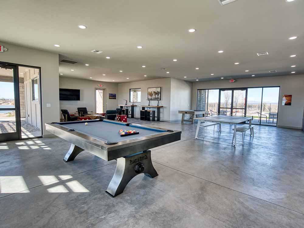 A pool table and ping pong table in the rec room at RIVER SANDS RV RESORT