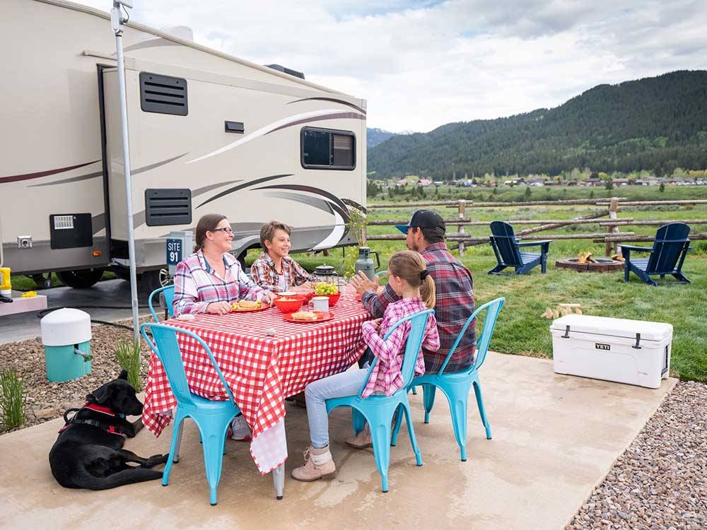 People eating around a table at ALPINE VALLEY RV RESORT
