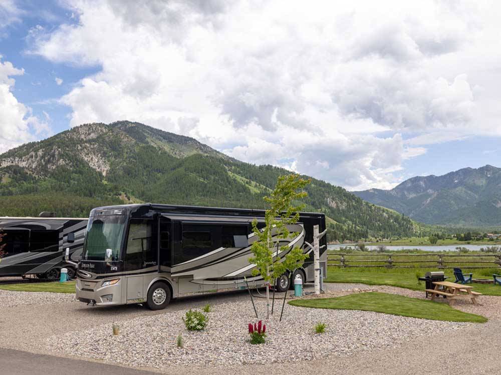An RV parked with mountains in the background at ALPINE VALLEY RV RESORT