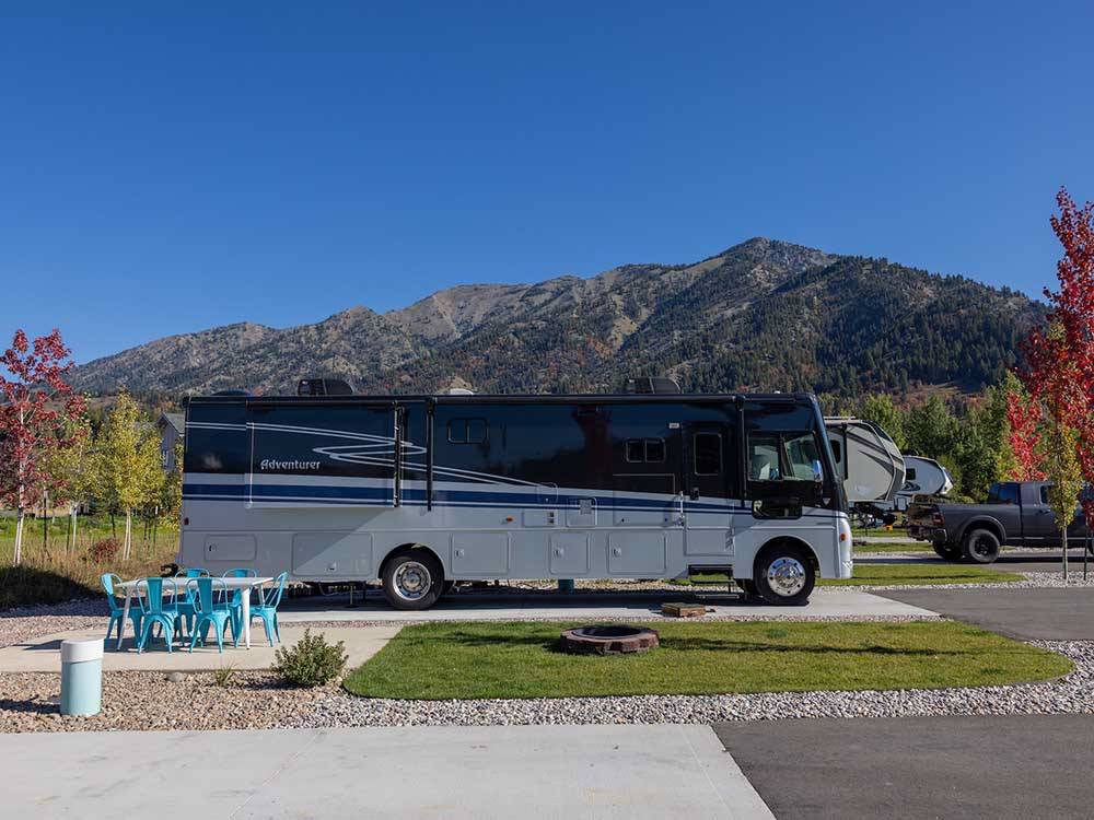 A large motorhome parked on-site at ALPINE VALLEY RV RESORT