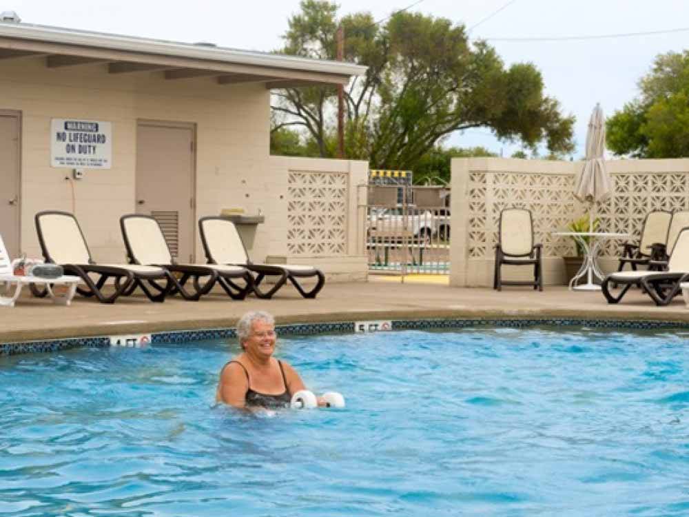 A woman in the swimming pool at ENCORE TRAILS END