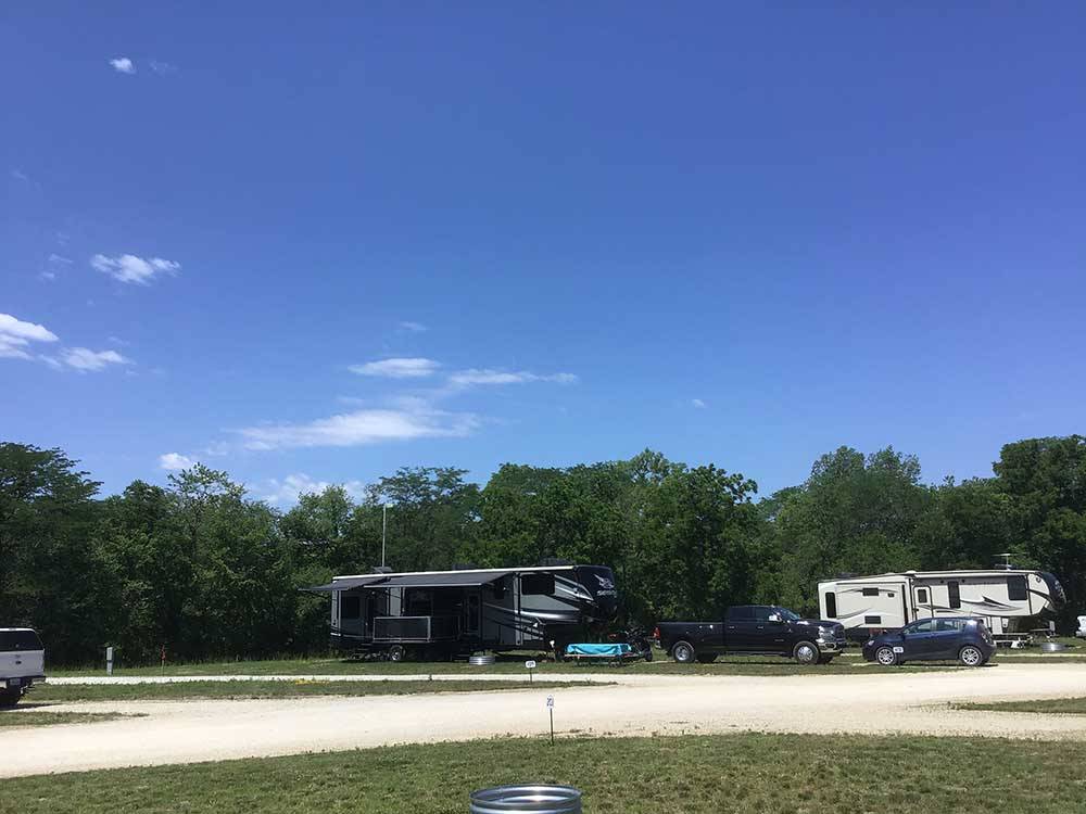 Row of campsites under clear blue sky at CROWS NEST RV RESORT