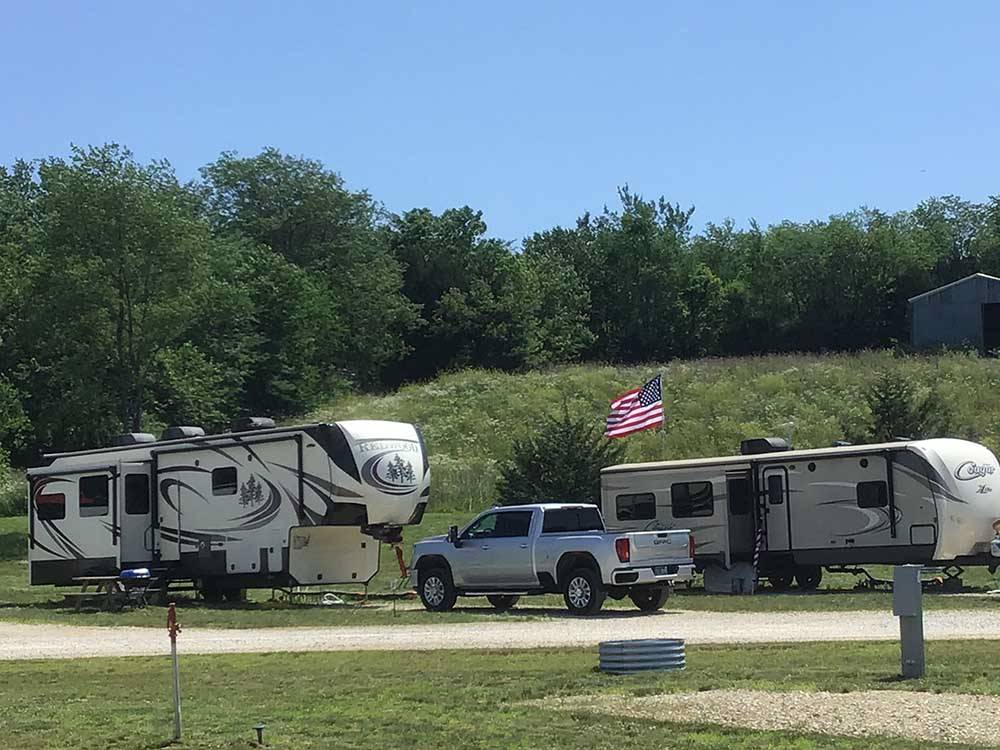 Fifth-wheel at campsite near gentle hill at CROWS NEST RV RESORT
